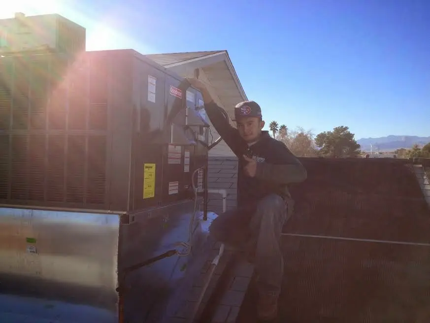 HVAC technician performing HVAC Inspection on a rooftop unit in Carolina Shores